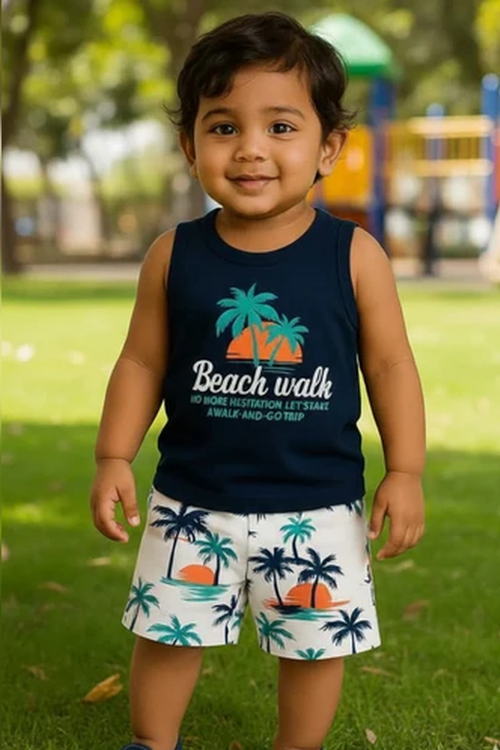 Boy wearing a navy sleeveless top with tropical print shorts two-piece summer set